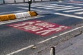 Huge sign for pedestrian priority, human being first, on the asphalt. city street.