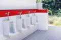 Outdoor urinal toilet old white and red color, the toilet of man with toilet view by urinals outdoors