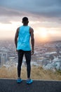 Outdoor vertical shot of active man goes in for sport regularly, wears sportshoes, t shirt and leggings, stands on