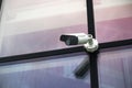 Outdoor video security camera on glass wall