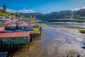 Outdoor view of beautiful coorful wooden houses on stilts palafitos, in a low tide day view in gorgeous sunny day in