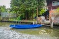 Outdoor view of blue plastic small boat at the riverside at yai canal or Khlong Bang Luang in Thailand