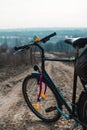 Outdoor view on classic bicycle detail. hilltop overlooking a valley in haze, a city on the horizon. winter or autumn landscape