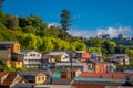 Outdoor view of colorful houses on stilts palafitos in the horizont located in Castro, Chiloe Island