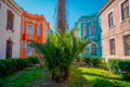 Outdoor view of of gorgeous garden with plants and palms between buildings in the Barrio Yungay in Santiago, capital of