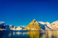 Outdoor view of mountain peaks covered with snow during winter in gorgeous blue sky Olenilsoya in Reine, Lofoten Islands Royalty Free Stock Photo