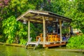 Outdoor view of pipeline close to a wooden building on the Chao Phraya river. Thailand, Bangkok Royalty Free Stock Photo