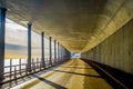 Outdoor view of road by the sea under a stoned tructure with columns and view to the sea during a gorgeous sunset in Royalty Free Stock Photo