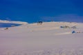 Outdoor view of some wooden houses almost covered with snow during heavy wsnowstorm, at the Gol Mountain Area Royalty Free Stock Photo