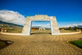 Outdoor view of stoned parking place with a stoned huge door in a beautiful day with blue sky and some clouds, with a