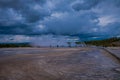 Outdoor view of tourists walking on a boardwalk in the horizont, around the Grand Prismatic Spring in Yellowstone