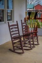 Outdoor view of two wooden rocking chairs in a balcony of a house in an amish farm