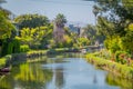 Outdoor view of unidentified people walking in the white bridge, and houses along a canal in Venice Beach, Los Angeles Royalty Free Stock Photo