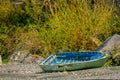 Outdoor view of wooden boat destoyed in the riverside of the lake in Vilupulli building sin the horizont located in Royalty Free Stock Photo