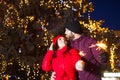 Outdoor waist up portrait of young couple embracing