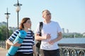 Outdoor walking man and woman, talking people, middle-aged couple Royalty Free Stock Photo