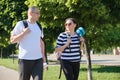 Outdoor walking man and woman, talking people middle-aged couple