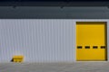 Outdoor warehouse painted bright yellow and gray