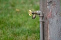 Outdoor water spigot fountain attached to a wooden porch, useful for campers