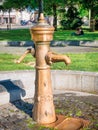 Outdoor water tap. Close up with a bronze vintage faucet in a park, locate in Vienna, Austria Royalty Free Stock Photo