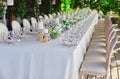 Outdoor wedding celebration at a restaurant. Festive table setting, catering. Wedding in rustic style in summer Royalty Free Stock Photo