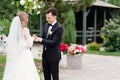 outdoor wedding ceremony in an arch of living flowers.newlyweds exchanged rings