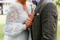 Outdoor wedding ceremony, close-up of the bride and groom hugging, holding hands with wedding rings. Royalty Free Stock Photo