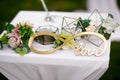 Outdoor wedding ceremony, decorated with a table with fresh flowers, an infinity sign and a glass box under the rings Royalty Free Stock Photo