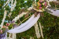 Outdoor wedding ceremony. Wedding decoration with flowers. Wedding floral arch with bouquet in garden. Marriage concept. Royalty Free Stock Photo
