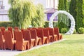 Outdoor wedding ceremony. Elegant decoration of a wedding ceremony outdoors. Outdoor wedding ceremony with brown chairs Royalty Free Stock Photo