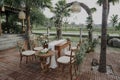 Outdoor wedding design with tables, chairs and an arch with flowers Royalty Free Stock Photo