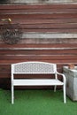 Outdoor white long chair wooden at smoking conner. Royalty Free Stock Photo