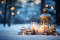 An outdoor winter scene with a lantern, candles, and holiday ornaments in the snow Royalty Free Stock Photo