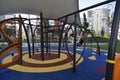 Outdoor wooden public playground equipment with climbing steps and slide.