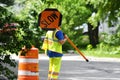 Outdoor worker hold slow sign at road construction site