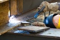 Outdoor worker with protective mask welding metal and sparks