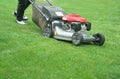 Outdoor worker working on mowing the lawn