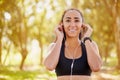 Outdoor workouts are awesome for your mood. a sporty young listening to music while working out outdoors. Royalty Free Stock Photo