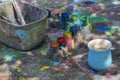 The outdoor workspace of a pottery painting art studio with color palette, brush, and unpainted pottery craft vase