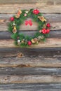Outdoor X-mas spruce wreath at old log cabin wall background Royalty Free Stock Photo
