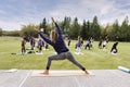 Outdoor Yoga classes. Group of adults attending yoga classes in the park Royalty Free Stock Photo