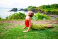 Outdoor yoga practice. Young woman practicing Urdhva Mukha Shvanasana, Upward facing dog pose as part of the Sun Salutation series Royalty Free Stock Photo