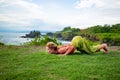 Outdoor yoga practice. Young woman practicing Ashtanga Namaskara, Eight limbed pose as part of the Sun Salutation series of asanas