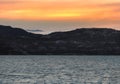 Outdoors awe body of frozen water winter season sunset behind the mountains