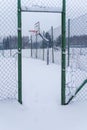 Outdoors basketball court covered with snow in winter