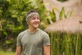Outdoors candid portrait of young attractive and happy hipster man enjoying tropical nature exploring exotic Asian tourist Royalty Free Stock Photo
