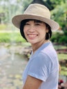 Outdoors close up portrait of girl smiling or asian woman smiling in the park and looking at camera Royalty Free Stock Photo