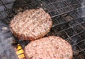 Outdoors cooking burgers on hot grill with flames Royalty Free Stock Photo