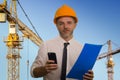 Corporate portrait of young attractive and successful engineer man or architect working on building at construction site wearing Royalty Free Stock Photo