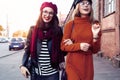 Outdoors fashion portrait young pretty best girls friends in friendly hug. Walking at the city. Posing at the street Royalty Free Stock Photo